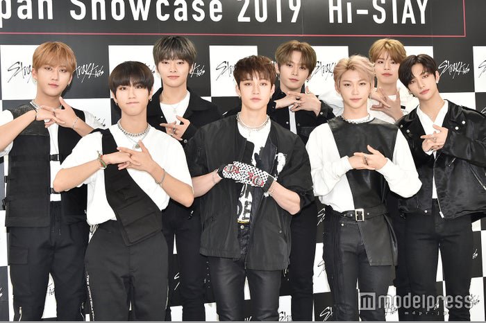 changbin, han ,i.n., bang chan, lee know, felix, seungmin and Hyunjin standing in front of a black and white background  